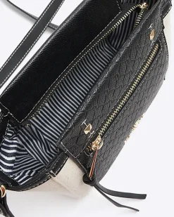 River Island canvas embossed RI cross body bag Black Sale