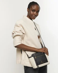 River Island canvas embossed RI cross body bag Black Sale