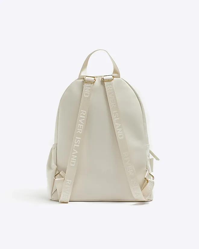 River Island Girls quilted bow detail backpack Cream Online