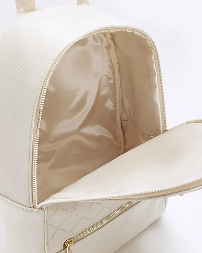 River Island Girls quilted bow detail backpack Cream Online